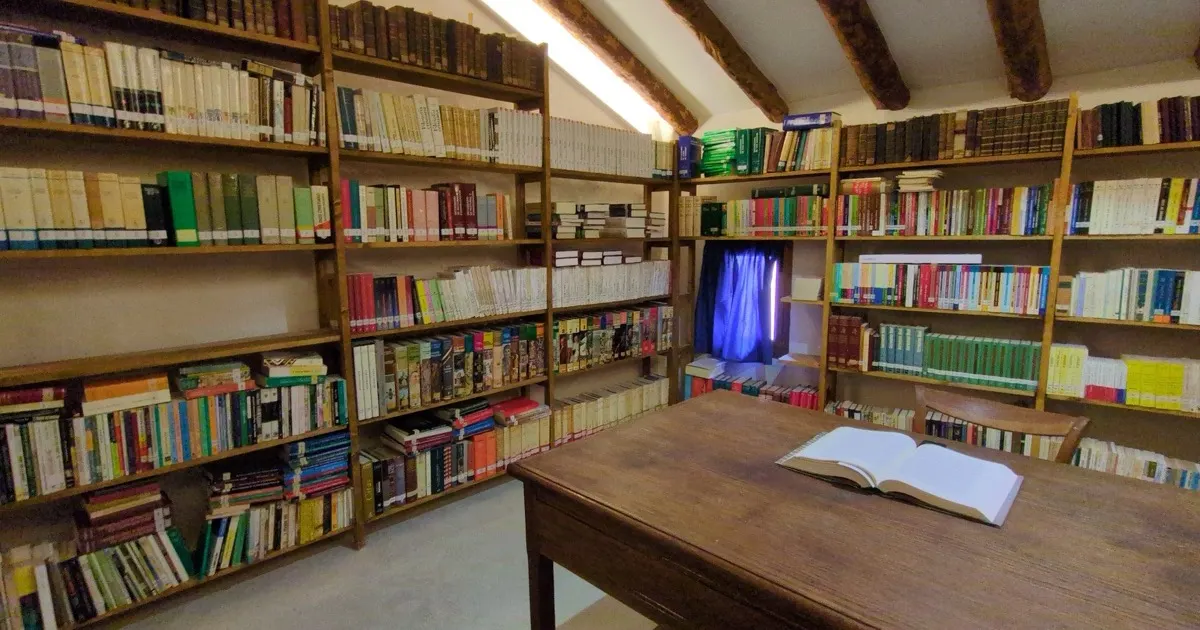 Library reading room with an open book on a wooden desk